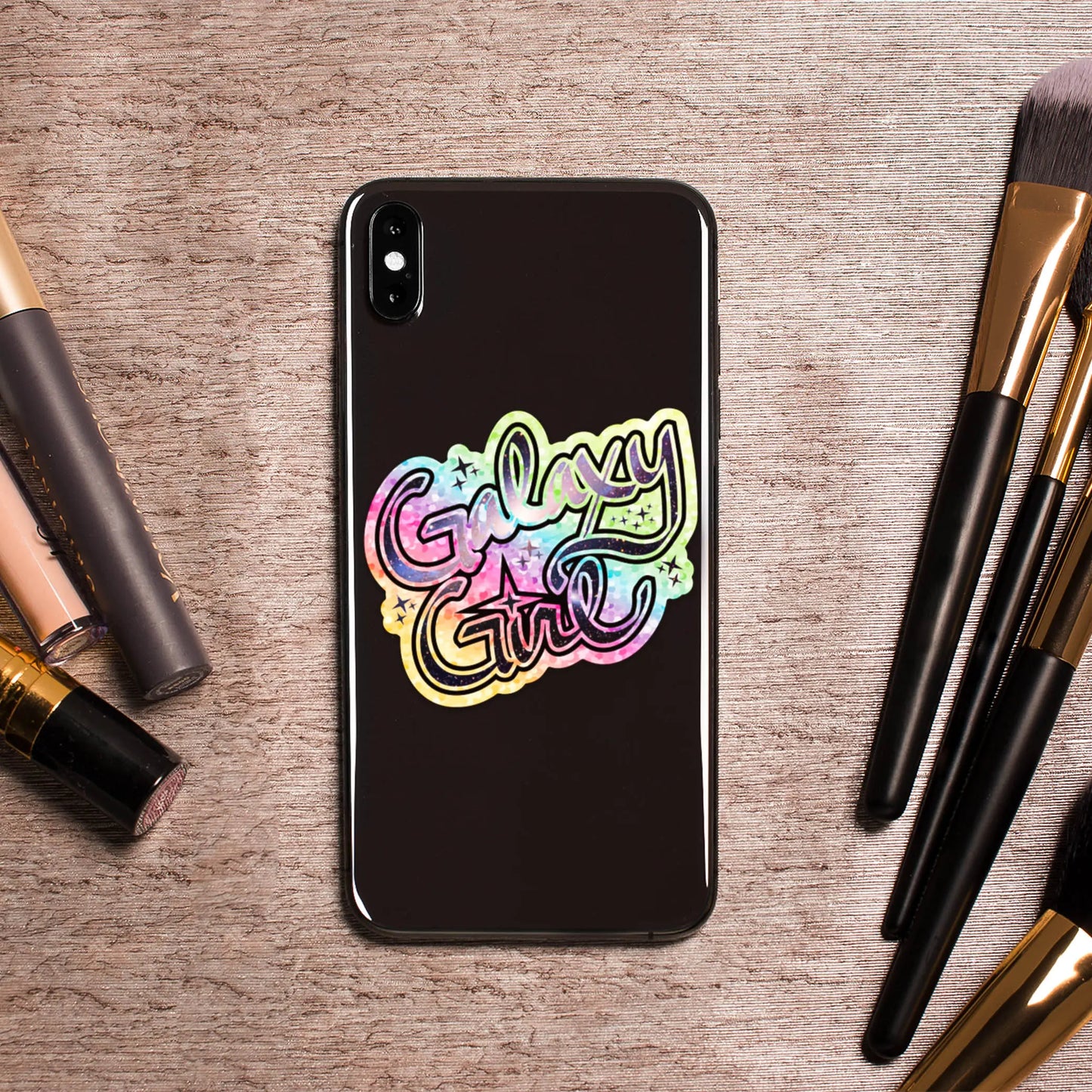 Galaxy Girl Die-Cut Sparkle 3" Vinyl Sticker on phone surrounded by cosmetics