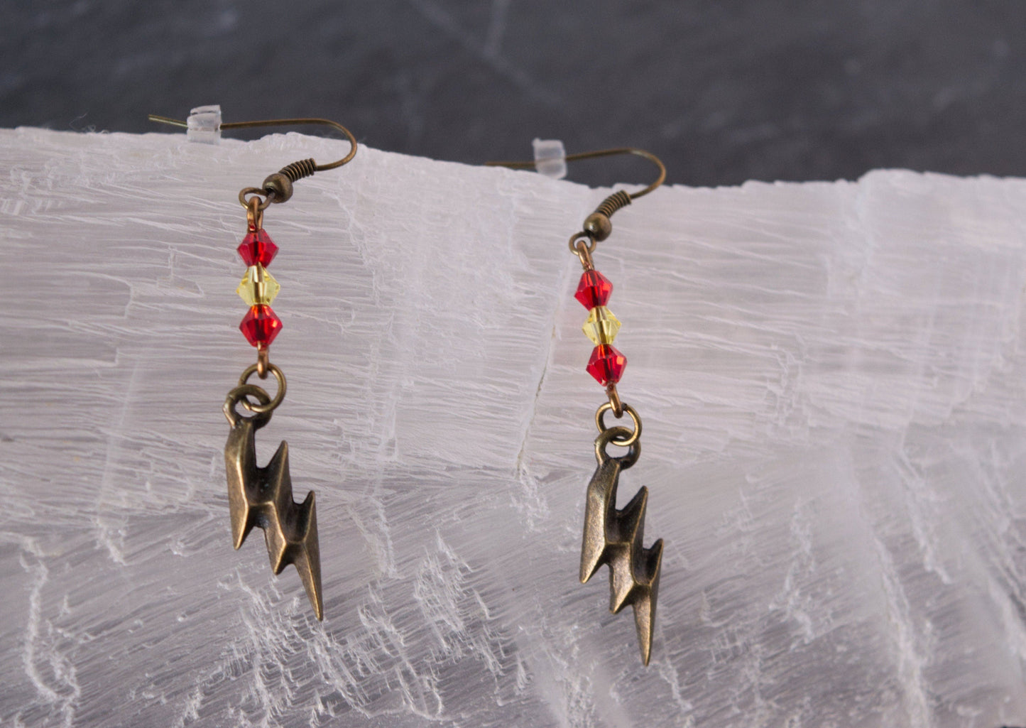 Antique Bronze and Glass Bead Lightning Bolt Earrings on selenite