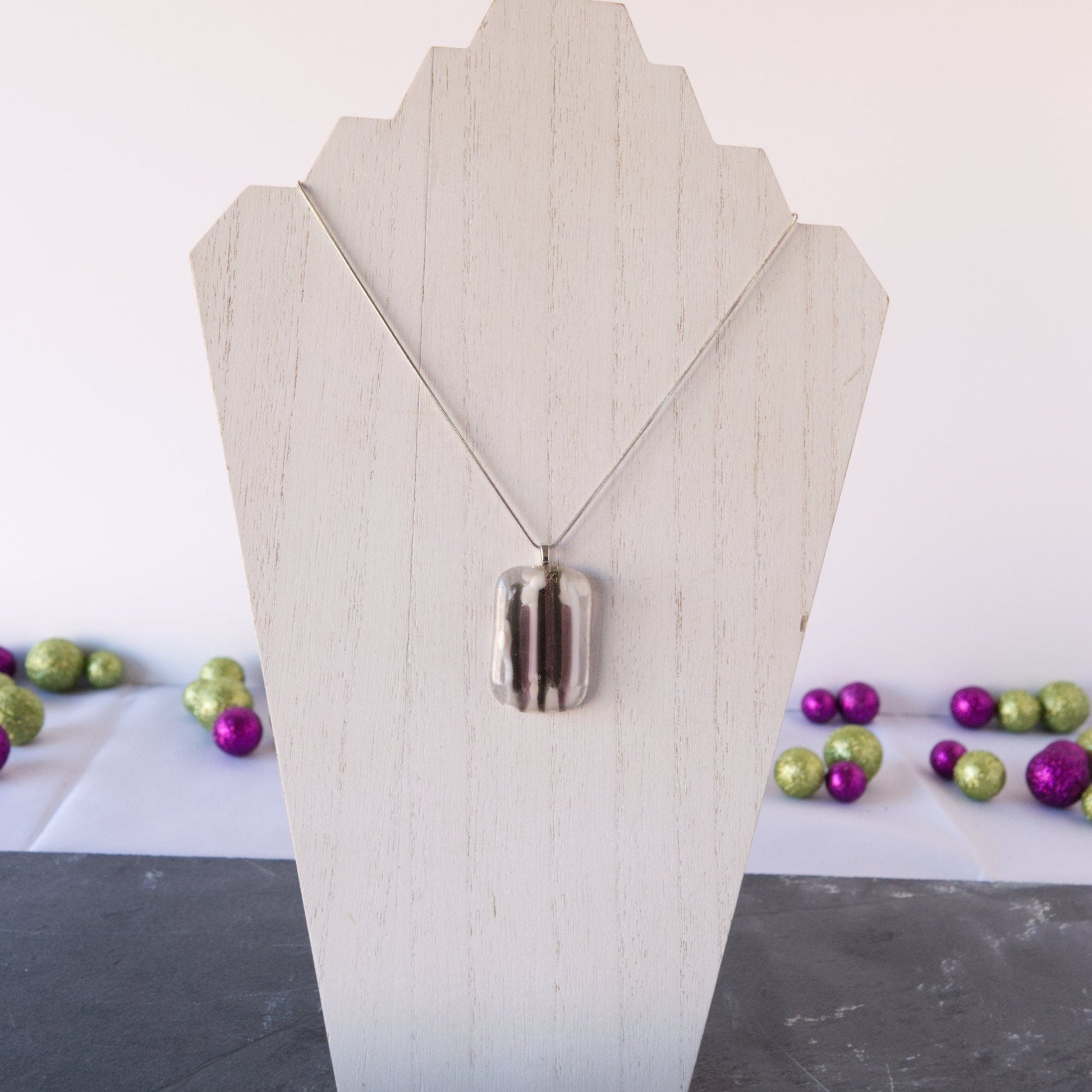 Purple and Gray Fused Glass Pendant Necklace on White Wood
