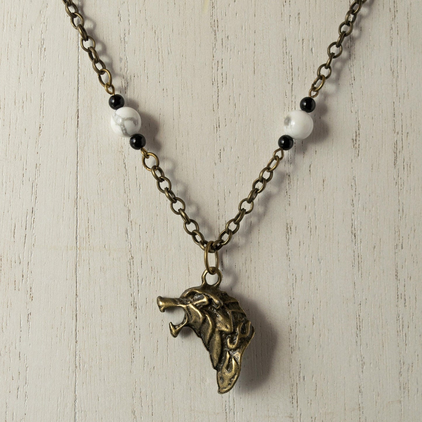 House Stark Dire Wolf Charm and Bead Necklace - Bronze on white wood