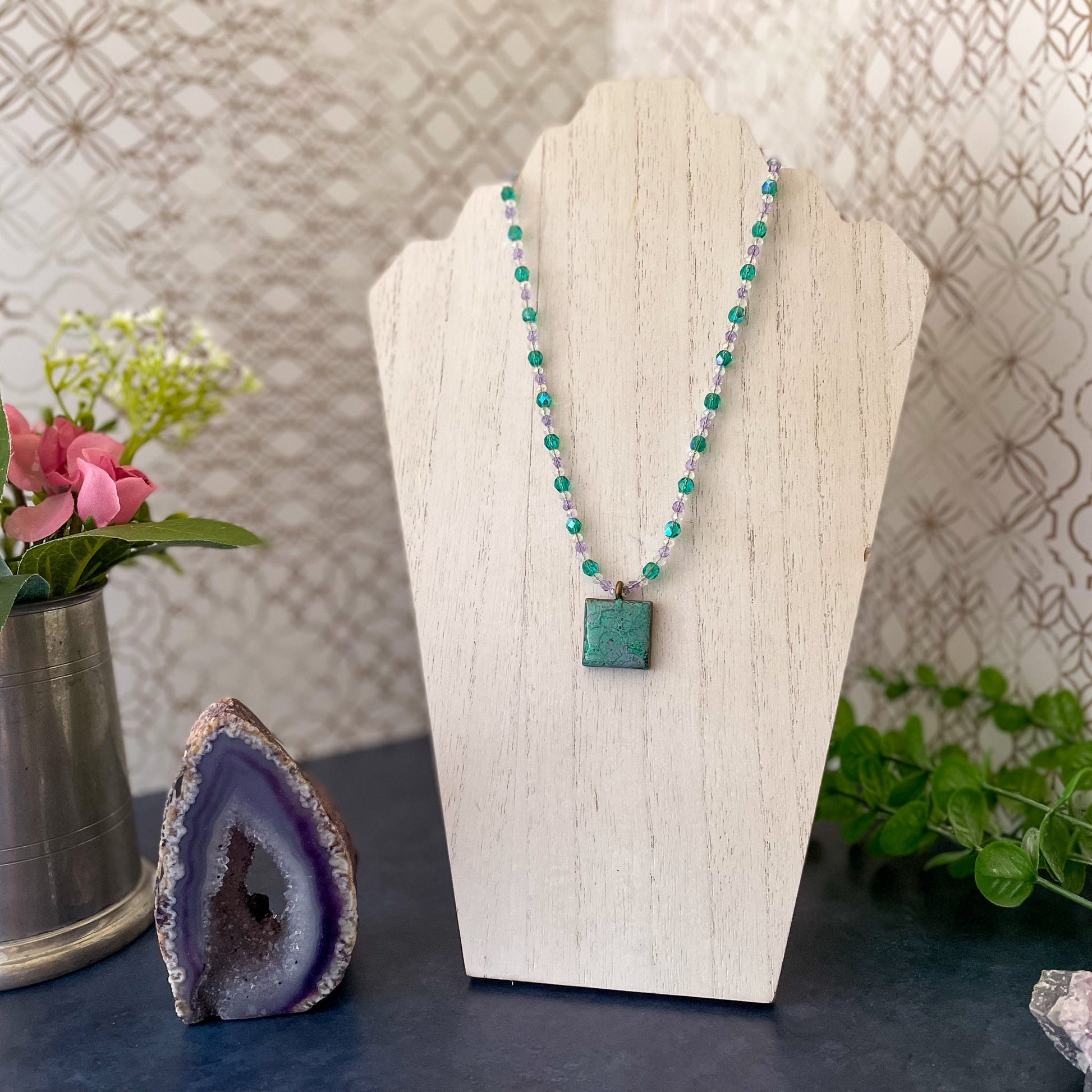 Aqua and Lavender Paisley Clay Pendant Bead Necklace on white wood