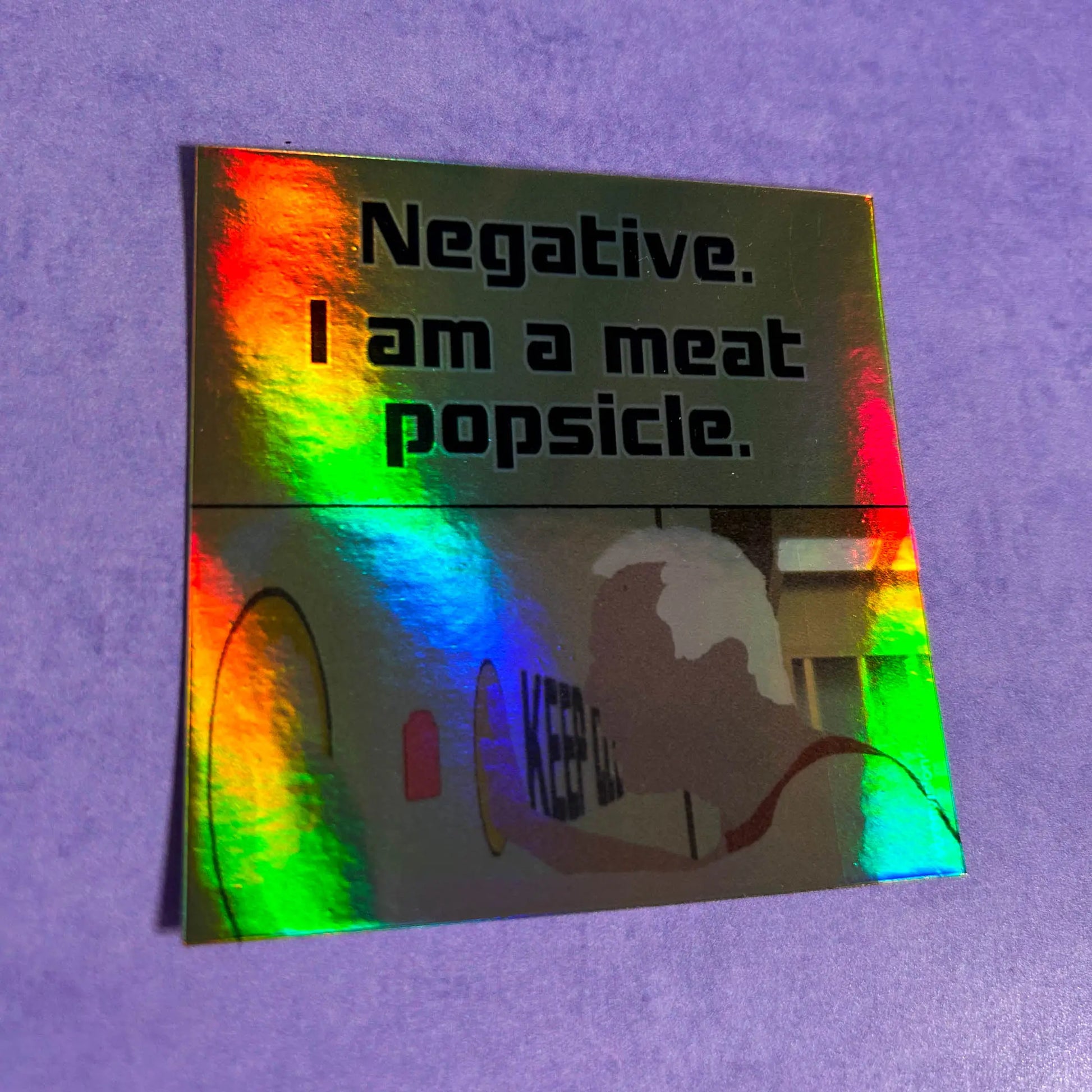 Meat Popsicle Holographic 3" Vinyl Sticker tilted right on a purple background