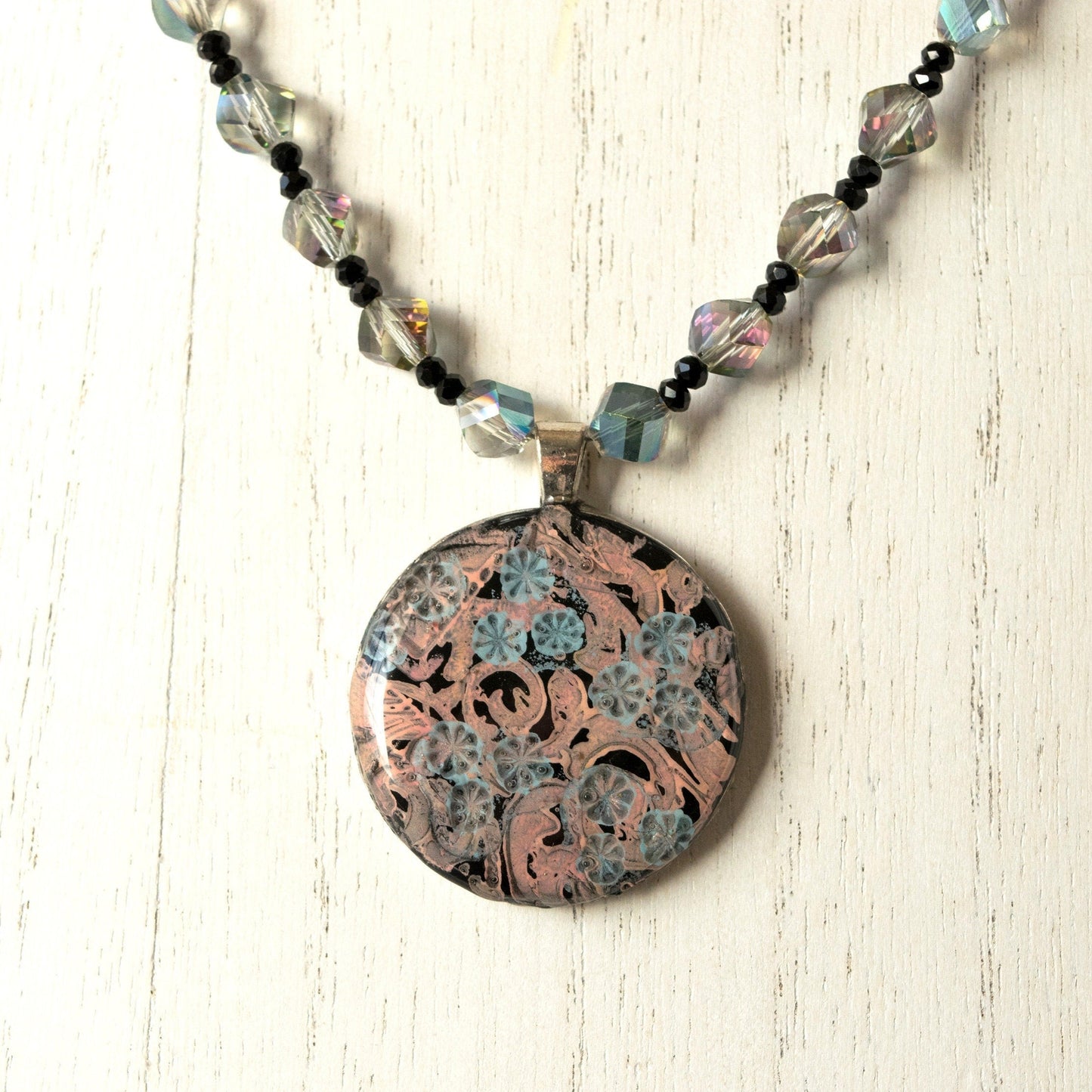 Floral Scroll Clay Pendant Bead Necklace on white wood